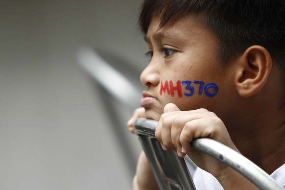 FILE - In this March 6, 2016, file photo, a Malaysian child has his face painted with MH370 during a remembrance event for the ill fated Malaysia Airlines Flight 370 in Kuala Lumpur, Malaysia. An inde ...