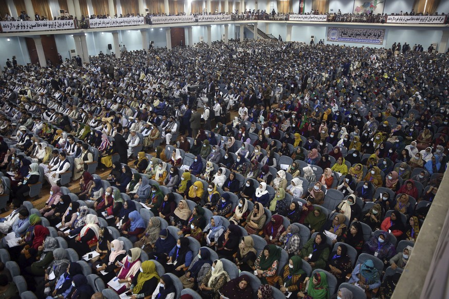 Delegates wearing a protective face masks to help curb the spread of the coronavirus attend an Afghan Loya Jirga meeting in Kabul, Afghanistan, Friday, Aug. 7, 2020. The traditional council opened Fri ...