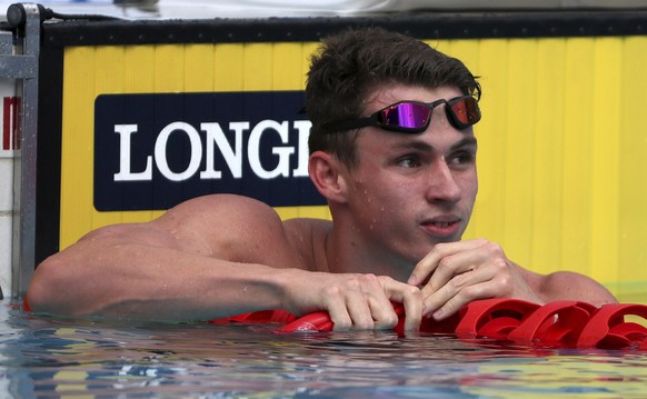 FILE- England&#039;s Ben Proud reacts after he was disqualified in his men&#039;s 50m butterfly heat during the 2018 Commonwealth Games at the Aquatic Centre on the Gold Coast, Australia, Thursday, Ap ...