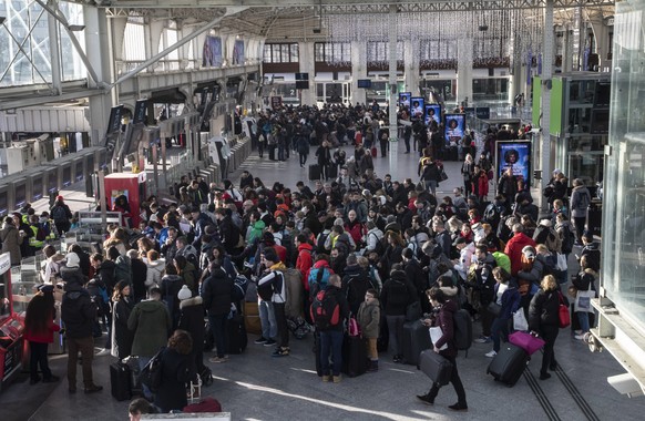 Travelers waiting to to board a train at Gare de Lyon train station in Paris, Sunday, Dec. 29, 2019. Strikes, which began Dec. 5, have disrupted transport across France and beyond, hobbling Paris Metr ...