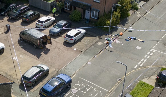 Police tape cordons off the scene of an attack in Hainault, north east London, Tuesday April 30, 2024. A man wielding a sword attacked members of the public and police officers in a east London suburb ...