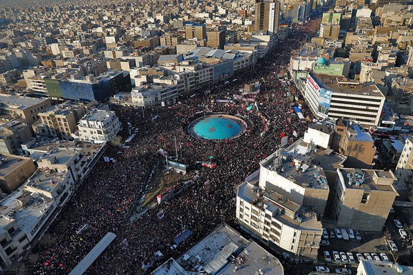 In this aerial photo released by an official website of the office of the Iranian supreme leader, mourners attend a funeral ceremony for Iranian Gen. Qassem Soleimani and his comrades, who were killed ...