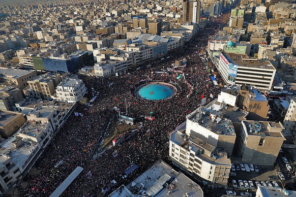 In this aerial photo released by an official website of the office of the Iranian supreme leader, mourners attend a funeral ceremony for Iranian Gen. Qassem Soleimani and his comrades, who were killed ...