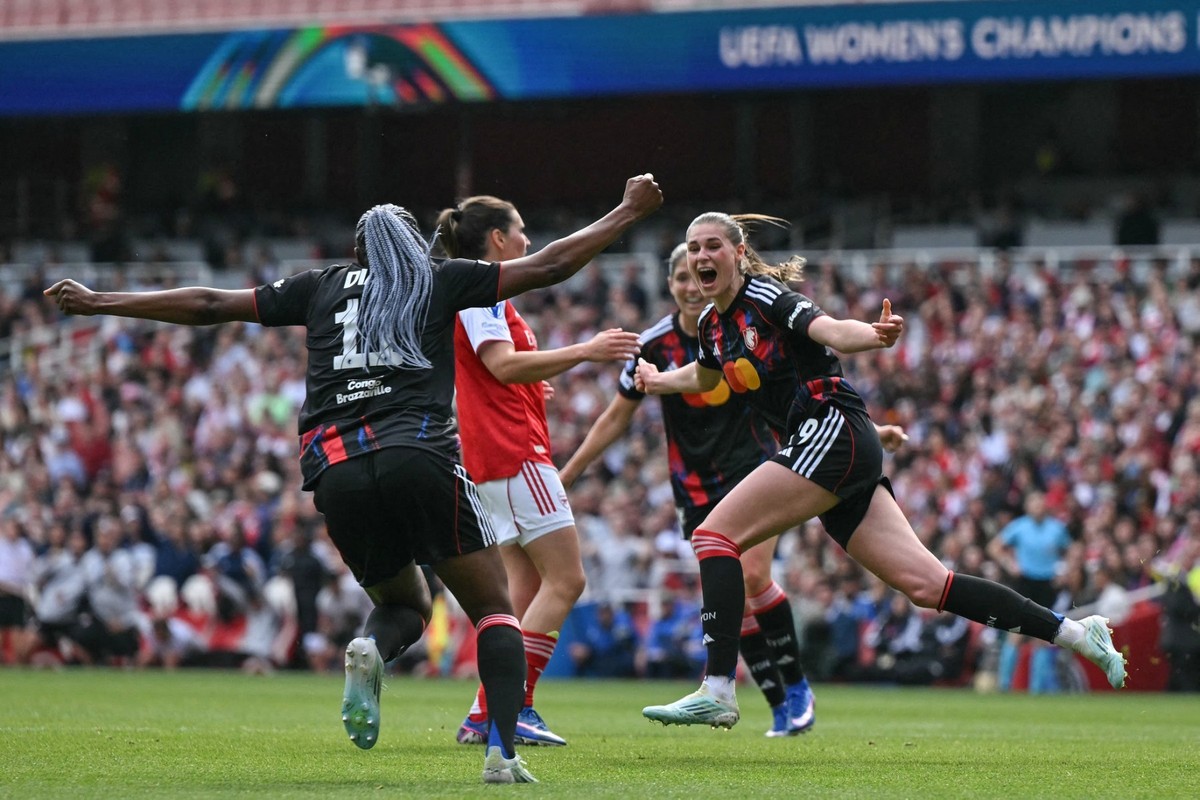 Lyon's German striker #29 Jule Brand (R) celebrates after scoring her team's first goal during the women's UEFA Champions League first-leg semi-final football match between Arsenal and  ...