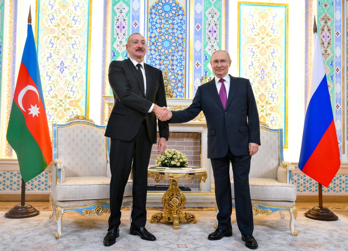 Russian President Vladimir Putin, right, and Azerbaijan's President Ilham Aliyev shake hands prior to their talks on the sidelines of the Russia-Central Asia summit in Dushanbe, Tajikistan, on Th ...