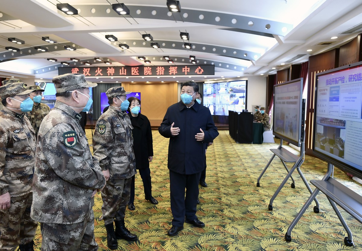 In this photo released by China's Xinhua News Agency, Chinese President Xi Jinping, right, is briefed about the Huoshenshan Hospital in Wuhan in central China's Hubei Province, Tuesday, Marc ...