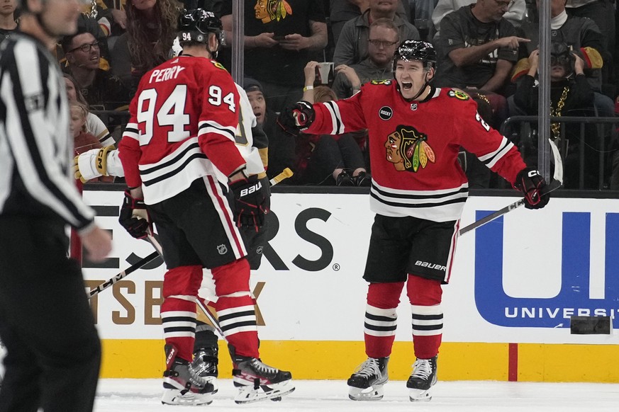 Chicago Blackhawks center Philipp Kurashev, right, celebrates after scoring against the Vegas Golden Knights during overtime of an NHL hockey game Friday, Oct. 27, 2023, in Las Vegas. (AP Photo/John L ...