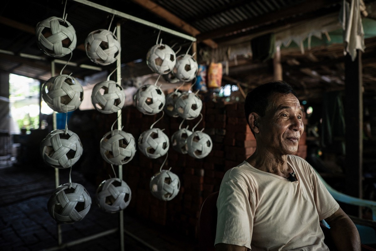 This photo taken on May 8, 2025 shows Mg Kaw, owner of a production workshop for chinlone balls, used in the ancient Myanmar game considered a blend between sport and art, in Hinthada township in the  ...