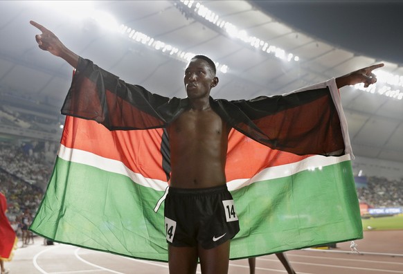 FILE - In this Friday, Oct. 4, 2019 file photo, Conseslus Kipruto of Kenya, gold medal winner in the the men&#039;s 3000 meter steeplechase final, celebrates at the World Athletics Championships in Do ...