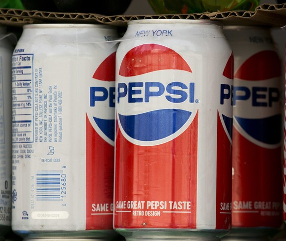 FILE- In this May 7, 2018, file photo, cans of Pepsi are displayed in New York. PepsiCo Inc. reports earns on Tuesday, July 10. (AP Photo/Mark Lennihan, File)