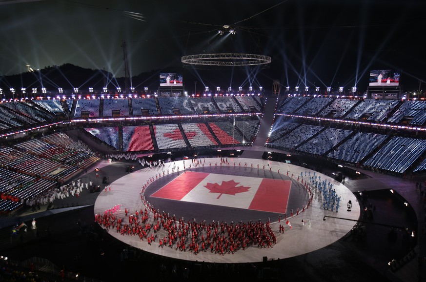 The team from Canada arrive on stage during the opening ceremony of the 2018 Winter Olympics in Pyeongchang, South Korea, Friday, Feb. 9, 2018. (AP Photo/Charlie Riedel)