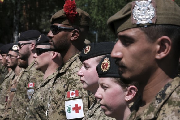 epa12199106 NATO Multinational Brigade troops attend a formal ceremony to mark the Transfer of Command Authority of NATO Multinational Brigade Latvia from Canadian Armed Forces Colonel (OF-5) Cedric A ...
