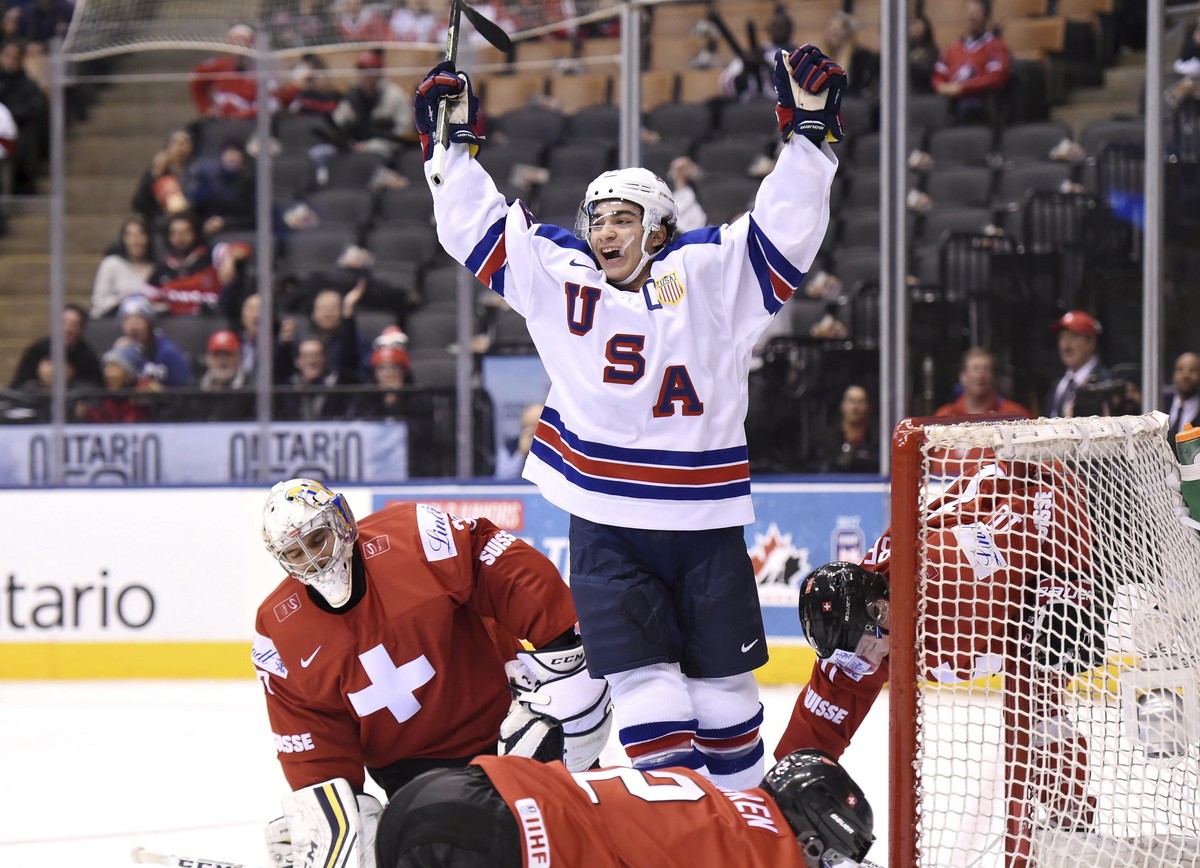 USA's Luke Kunin (9) celebrates his goal past Switzerland goaltender Joren van Pottelberghe (30) during the first period of a quarterfinal hockey game at the world junior championship in Toronto, ...