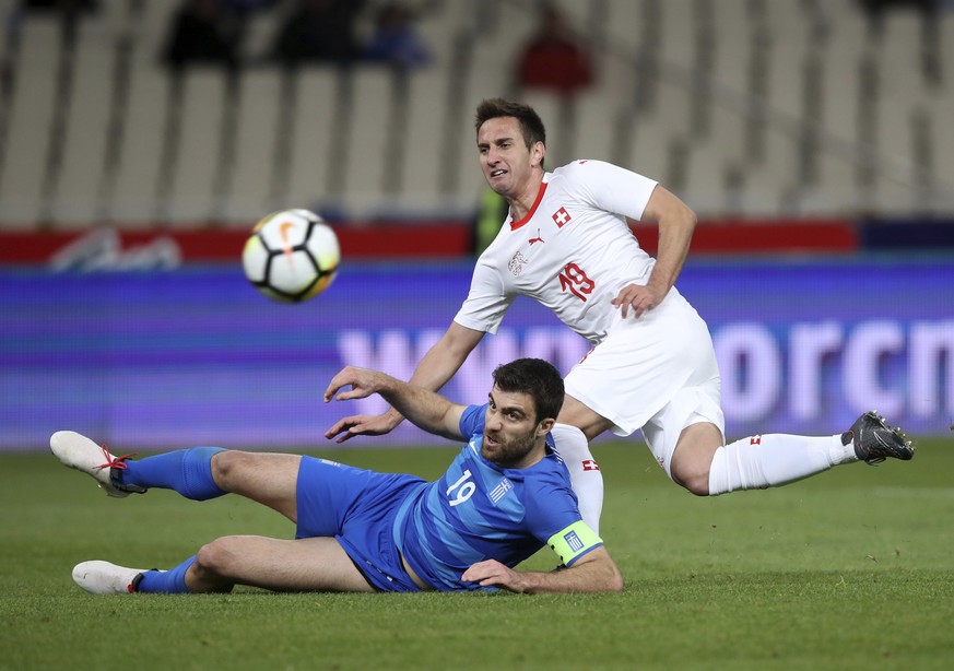 Greece&#039;s Sokratis Papastathopoulos, left, duels for the ball with Switzerland&#039;s Mario Gavranovic during an international friendly soccer match between Greece and Switzerland at the Olympic s ...