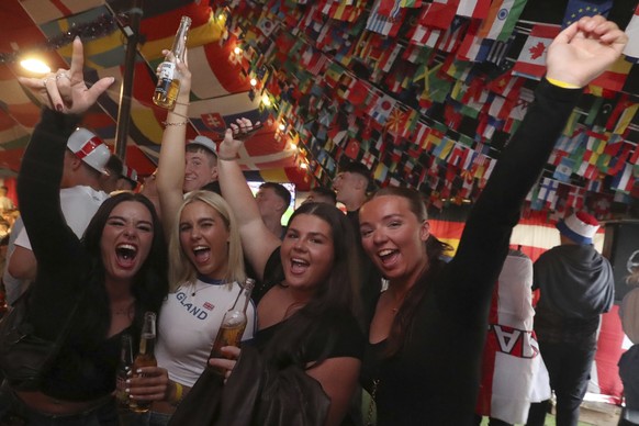 England react as they watch the Group C match between Serbia and England in the Euro 2024 soccer tournament on large TV screens at the Douglas Tavern in Hebburn, England, Sunday, June 16, 2024. (AP Ph ...