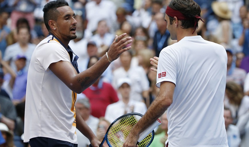 Roger Federer, right, of Switzerland, shakes hands with Nick Kyrgios, of Australia, after Federer defeated Kyrgios during the third round of the U.S. Open tennis tournament, Saturday, Sept. 1, 2018, i ...