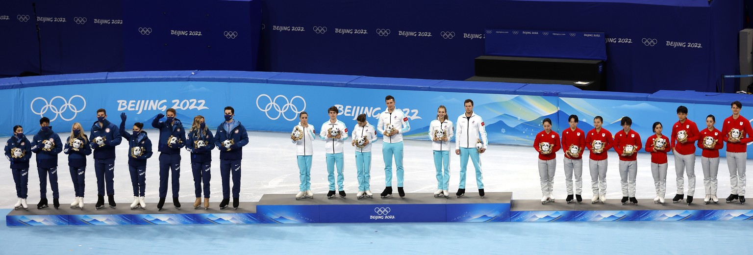 epa09734447 (L-R) Silver medalists team USA, gold medalists team Russia and bronze medalists team Japan celebrate during the medal ceremony of Figure Skating Team Event at the Beijing 2022 Olympic Gam ...