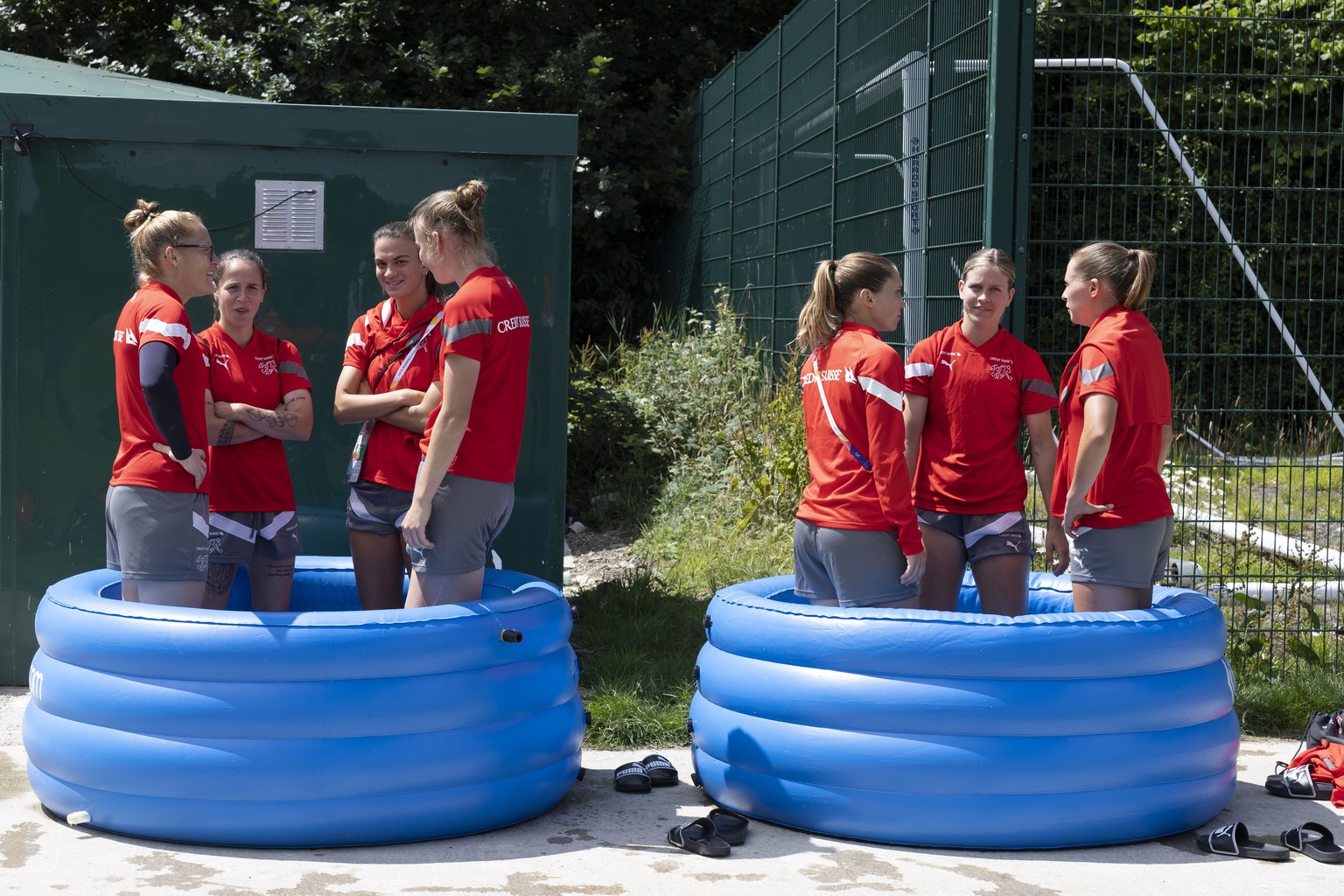 epa10057256 Switzerland&#039;s players cool off in inflatable pools of ice water after a training session of the Team Switzerland at the Town Academy Training Ground, at the UEFA Women&#039;s EURO 202 ...