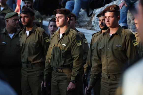 epa11720718 Israeli soldiers stand before the coffin of late comrade Itay Markowitz during his funeral in Kokhav Yair, a town in central Israel, 14 November 2024. According to the Israeli army, six so ...