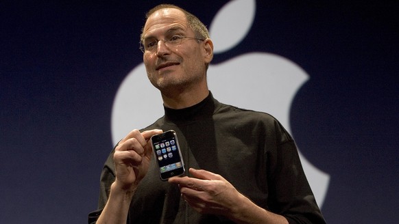 SAN FRANCISCO, CA - JANUARY 9: Apple CEO Steve Jobs holds up the new iPhone that was introduced at Macworld on January 9, 2007 in San Francisco, California. The new iPhone will combine a mobile phone, ...