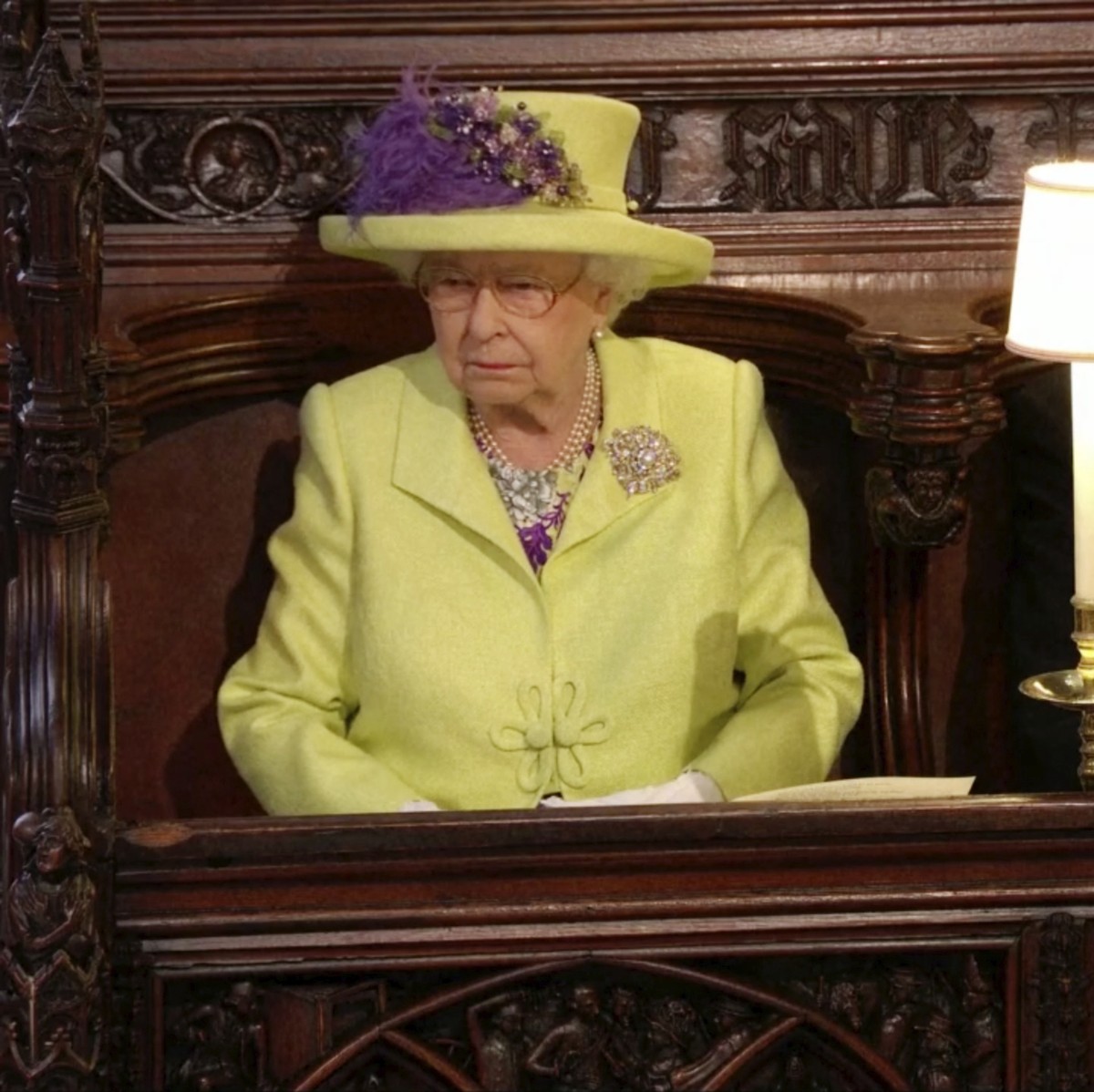 In this frame from video, Britain's Queen Elizabeth, left, Prince Philip, the Duke of Edinburgh, top right, and Britain's Prince William watch the wedding ceremony of Britain's Prince H ...