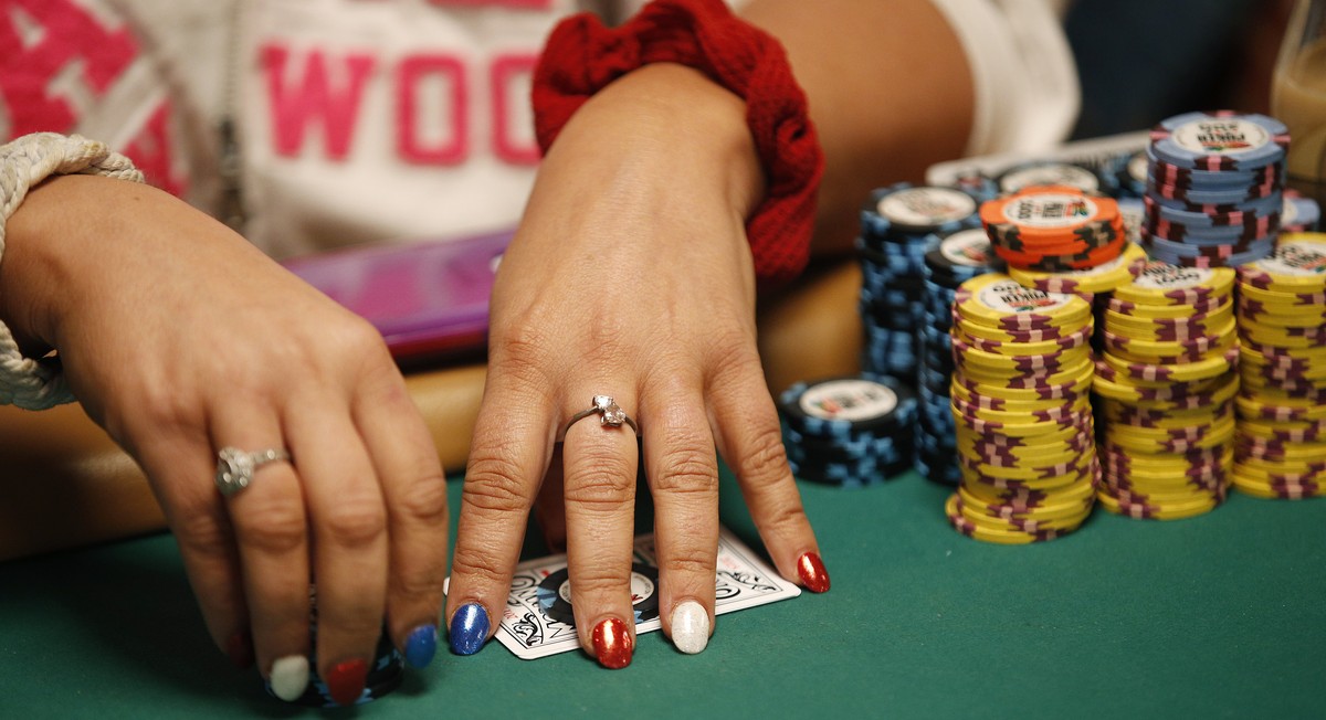 In this June 27, 2015, photo, Tanya Stendzis holds her cards while playing in the Ladies No-Limit Hold'em Championship during the World Series of Poker in Las Vegas. Poker is still a man's g ...