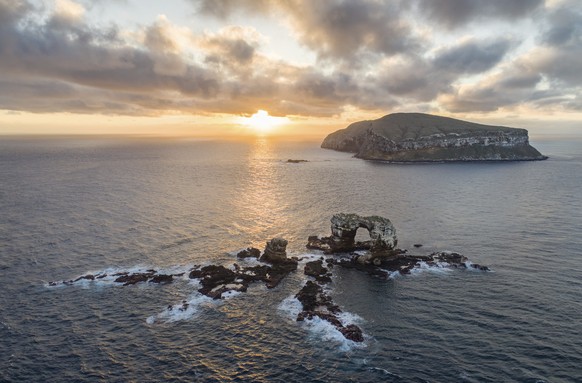 This 2017 photo provided by Simon Pierce shows the Darwin Arch, foreground, and Darwin Island, right, in the Galapagos Islands area of Ecuador. In an attempt to solve some of the most enduring mysteri ...