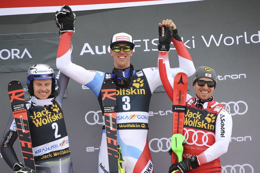 From left, second placed Henrik Kristoffersen of Norway, winner Ramon Zenhaeusern of Switzerland and third placed Marcel Hirscher of Austria celebrate on the podium of an Alpine Skiing World Cup men&# ...