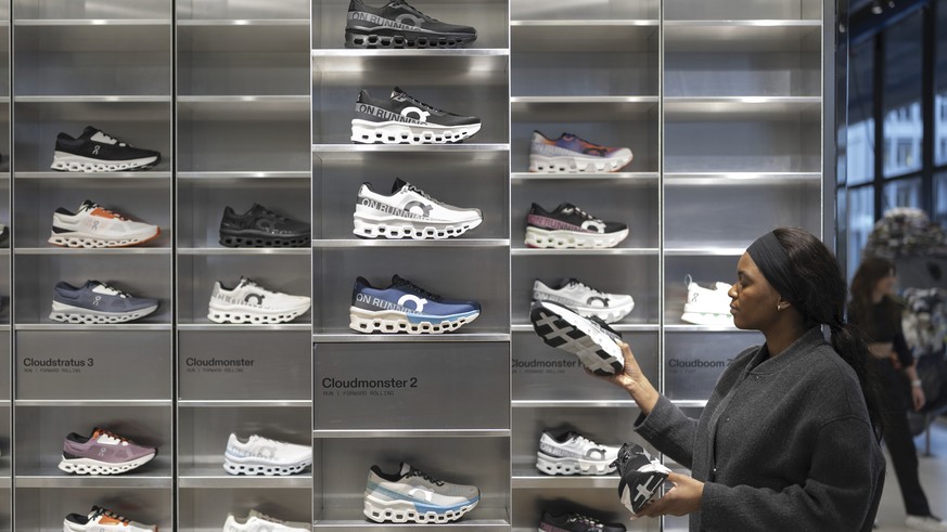 FILE - An employee at On tidies up sports shoes from the On sports brand in the On store on Wednesday, Jan. 22, 2025, at On's headquarters in Zurich. (Gaetan Bally/Keystone via AP)
Switzerland Tr ...