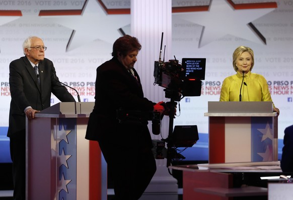 Democratic presidential candidates, Sen. Bernie Sanders, I-Vt, and Hillary Clinton wait during a short break at a Democratic presidential primary debate at the University of Wisconsin-Milwaukee, Thurs ...