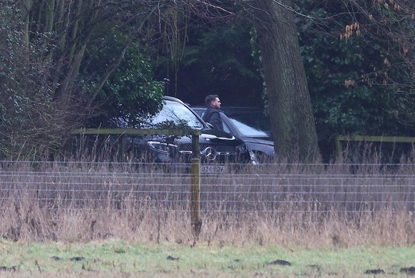 SANDRINGHAM, NORFOLK - FEBRUARY 19: A man steps out of an unmarked car at the home of Andrew Mountbatten-Windsor on February 19, 2026 in Sandringham, Norfolk. Andrew Mounbatten-Windsor has been arrest ...