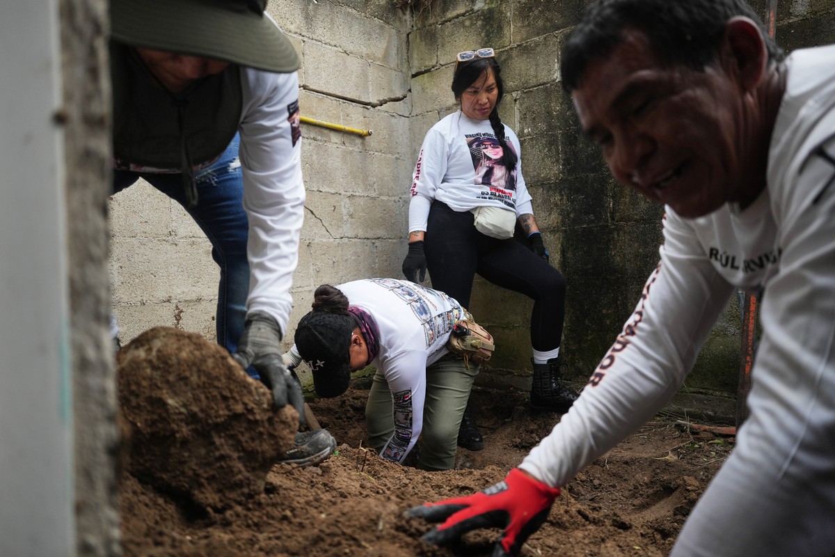 KEYPIX - Relatives of missing people, part of a group called the Guerreros Buscadores, inspect an area where they suspect bodies may be buried, in the Valle de los Olivos neighborhood of Guadalajara,  ...