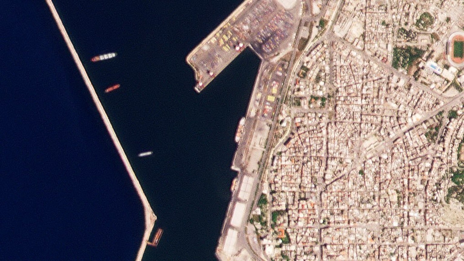 This satellite image from Planet Labs PBC shows the Russian-flagged ship Matros Pozynich, center, inside the harbor of Latakia, Syria, Tuesday, May 10, 2022. Satellite photos analyzed by The Associate ...