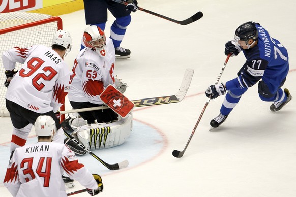 Finland&#039;s defender Markus Nutivaara, right, scores the 1:0 against Switzerland&#039;s goaltender Leonardo Genoni #63, past Switzerland&#039;s forward Gaetan Haas #92 and Switzerland&#039;s defend ...