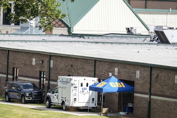 Georgia Bureau of Investigation staff move through an entrance to Apalachee High School after Wednesday&#039;s multiple shooting, Thursday, Sept. 5, 2024, in Winder, Ga. (AP Photo/Mike Stewart)WLD