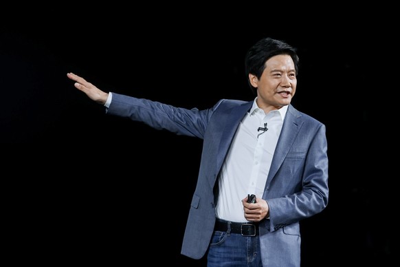 epa09107928 A handout photo made available by Xiaomi on 31 March 2021 shows Lei Jun, one of the co-founders of Xiaomi, speaking during the new products unveiling event in Beijing, China, 30 March 2021 ...