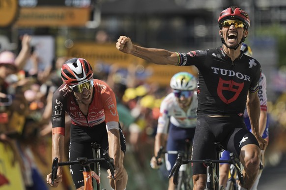 France&#039;s Julian Alaphilippe celebrates his third place when crossing the finish line with Spain&#039;s Carlos Rodriguez, left, during the fifteenth stage of the Tour de France cycling race over 1 ...