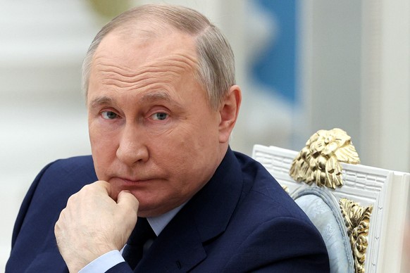FILE - Russian President Vladimir Putin listens during a meeting of the Russia the Land of Opportunity Supervisory Board at the Kremlin, in Moscow, Russia, on April 20, 2022. Russia staved off a defau ...