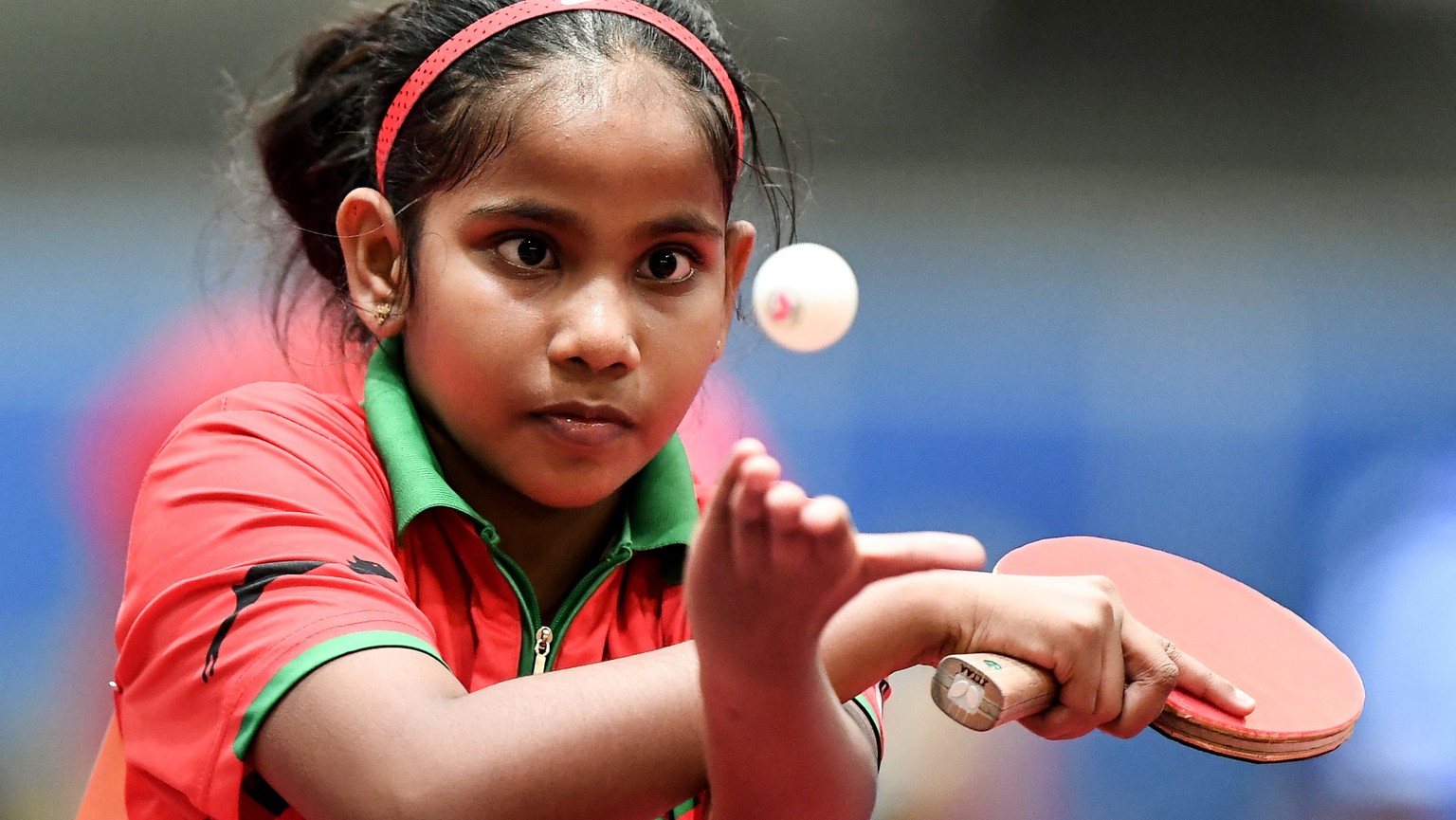 epa06701584 Ten-year-old Fathimath Dheema of the Maldives in action against Beth Roberts of Wales during the game between the Maldives and Wales in the group stage of the Table Tennis Team World Champ ...