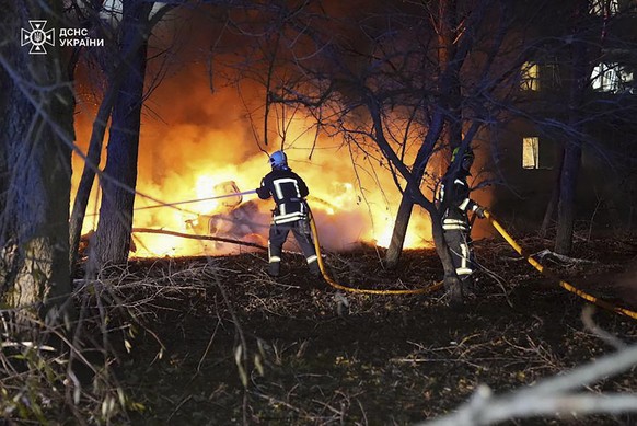 epa11726606 A handout photo released by the press service of the State Emergency Service (SES) of Ukraine shows Ukrainian rescuers working at the site of a rocket hit on a residential building in Sumy ...