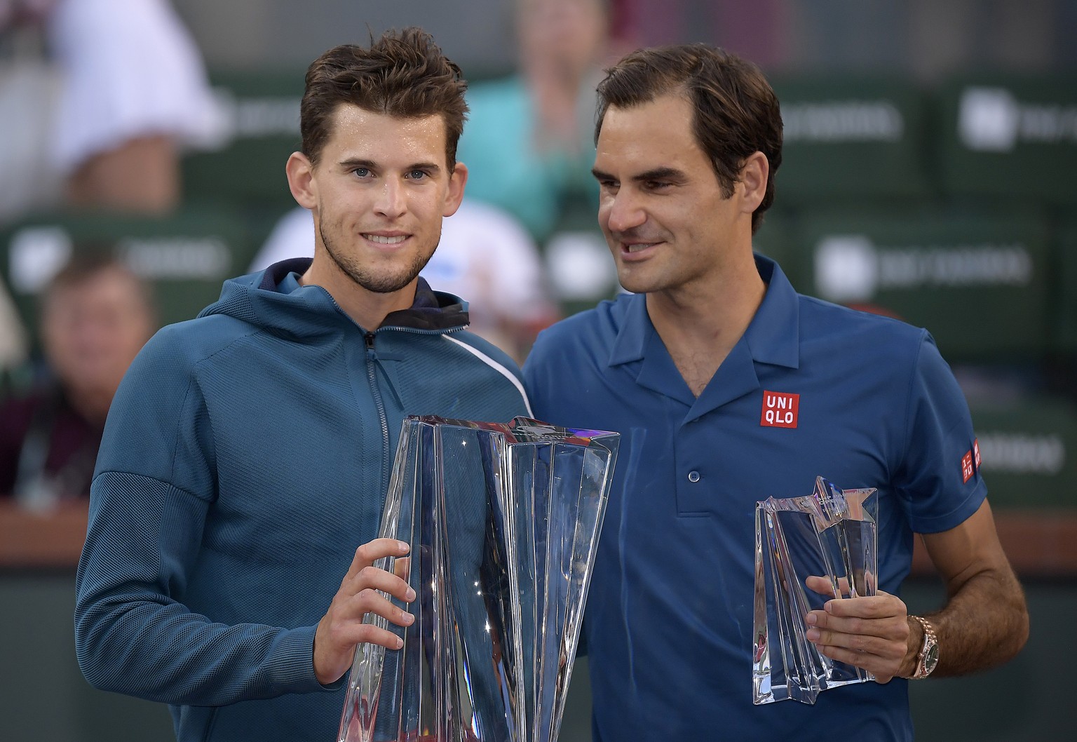 Dominic Thiem, of Austria, left, and Roger Federer, of Switzerland, pose with trophies after Thiem defeated Federer in the men&#039;s final at the BNP Paribas Open tennis tournament Sunday, March 17,  ...