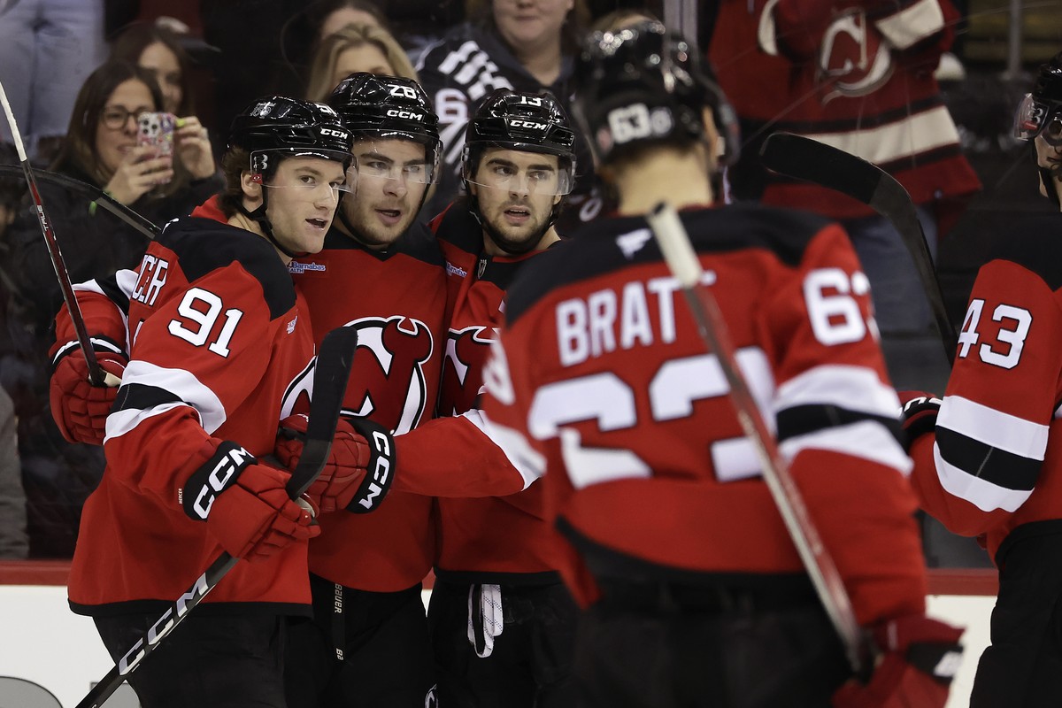 New Jersey Devils right wing Timo Meier (28) is congratulated by teammates after scoring during the second period of an NHL hockey game against the Vancouver Canucks, Monday, March 24, 2025, in Newark ...