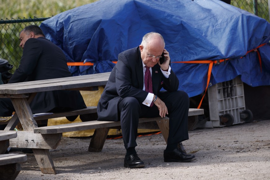 Former New York Mayor Rudy Giuliani speaks on the phone outside a meeting between Republican presidential candidate Donald Trump and local farmers at Bedners Farm Fresh Market, Monday, Oct. 24, 2016,  ...