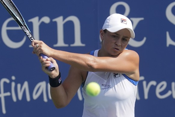 Ashleigh Barty, of Australia, returns a shot to Barbora Krejcikova, of the Czech Republic, during the Western &amp; Southern Open tennis tournament, Friday, Aug. 20, 2021, in Mason, Ohio. (AP Photo/Da ...