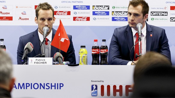 Patrick Fischer, left, head coach of Switzerland national ice hockey team, and Raeto Raffainer, right, Director of National Teams of the Swiss Ice Hockey, speak to the media during a press conference  ...