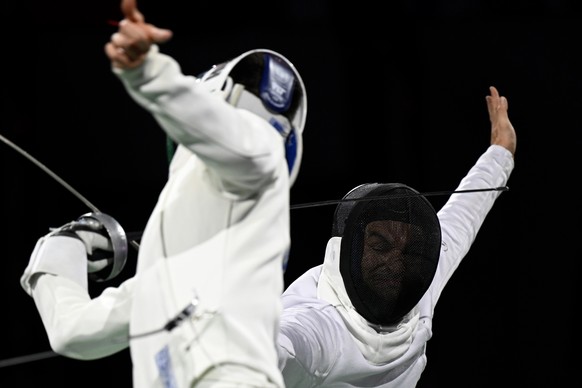 Lucas Malcotti of Switzerland, right, in action against Mate Tamas Koch of Hugary, at the 1/2 Final during the fencing Berne world cup tournament in Guemligen, Switzerland, Saturday, November 11, 2023 ...
