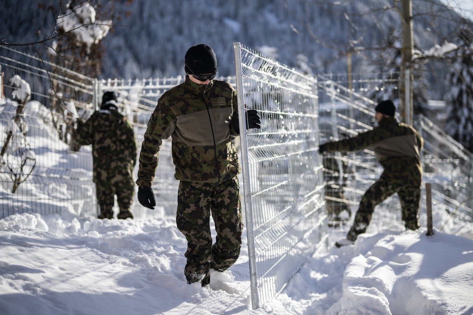 epa11064692 Members of the army set up fences in front of the congress center in Davos, Switzerland, 08 January 2024. The 54th annual meeting of the World Economic Forum (WEF) will run from 15 to 19 J ...