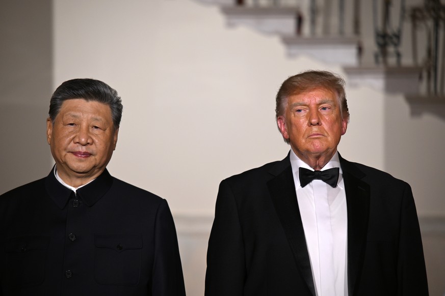 epa13261561 US President Donald J. Trump (R) greets President Xi Jinping (L) of The Peoples Republic of China in front of the Grand Staircase in the Grand Foyer of the White House in Washington, DC,  ...