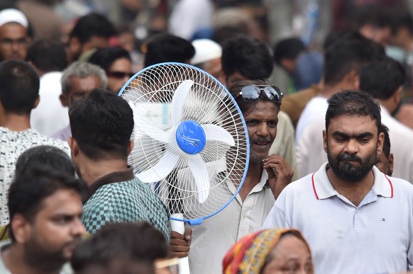 epa11450134 People buy room coolers and fans amid hot weather in Karachi, Pakistan, 01 July 2024. Hot and humid weather is expected to continue in Karachi for the next two days, with temperatures reac ...