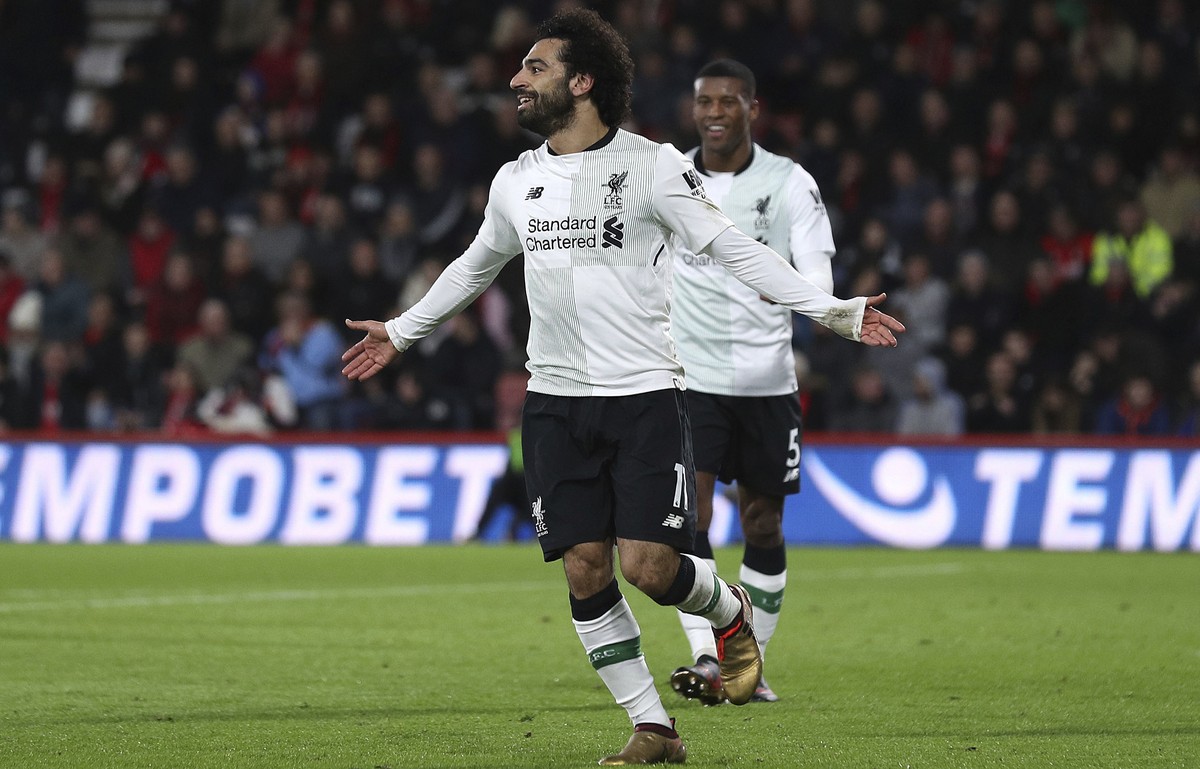 Liverpool's Mohamed Salah celebrates scoring his side's third goal against Bournemouth during the English Premier League soccer match at the Vitality Stadium in Bournemouth, England, Sunday  ...